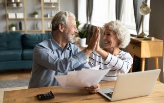 Smiling couple look at heating and cooling bill