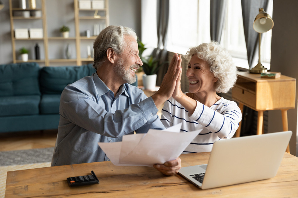 Smiling couple look at heating and cooling bill