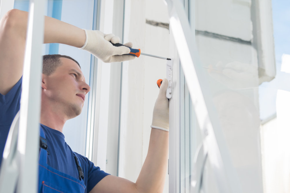 Worker reapiring window (Everything You Need To Know About Window Warranty)